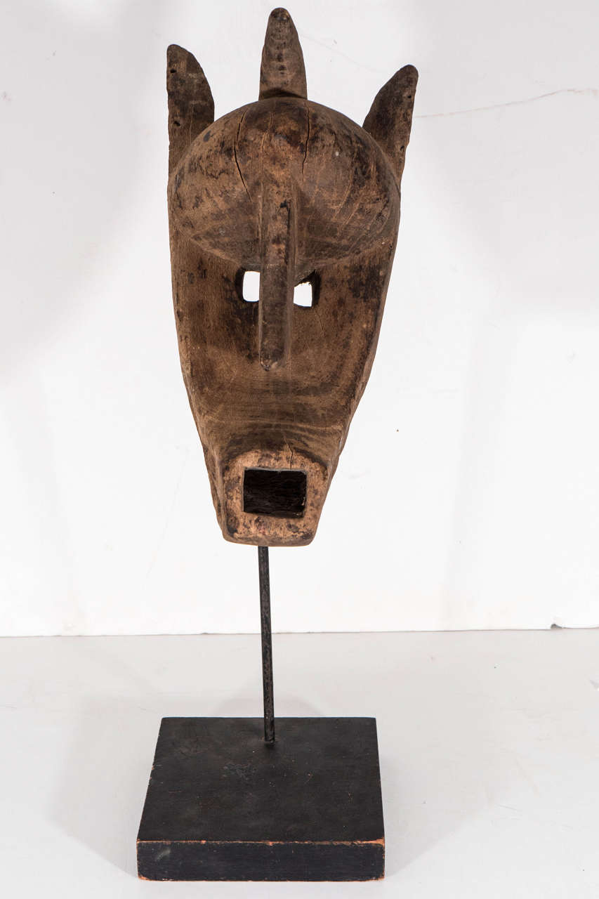 Bantu Fang tribal mask made of sandalwood on a pedestal mount.