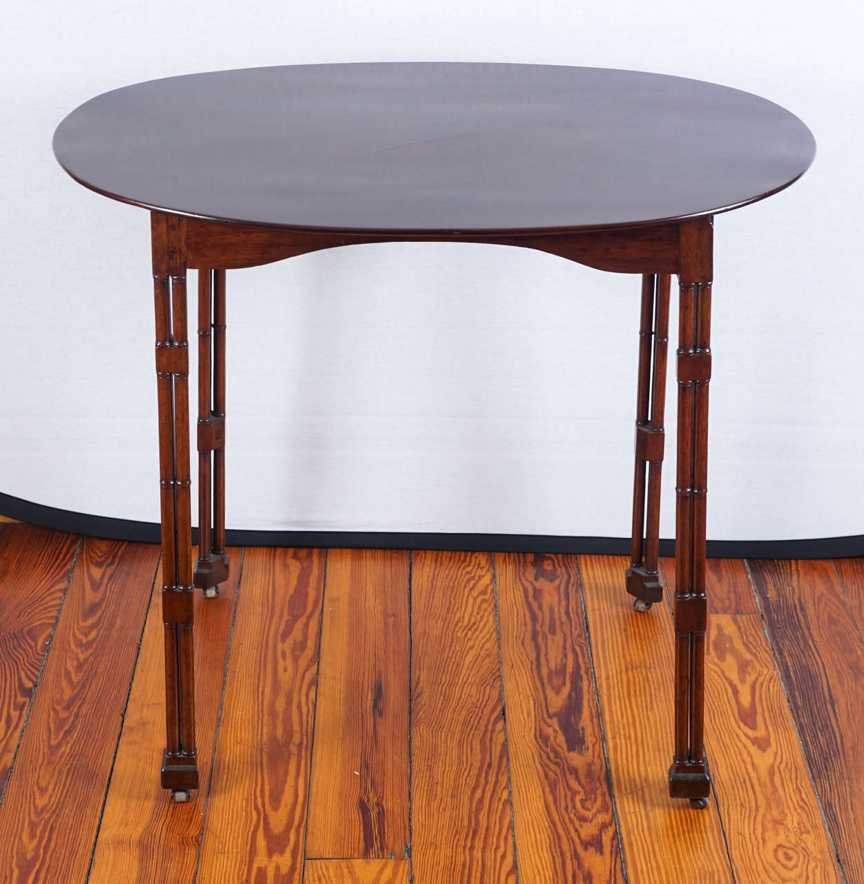 English Oval Topped Regency Mahogany Side Table on Casters For Sale