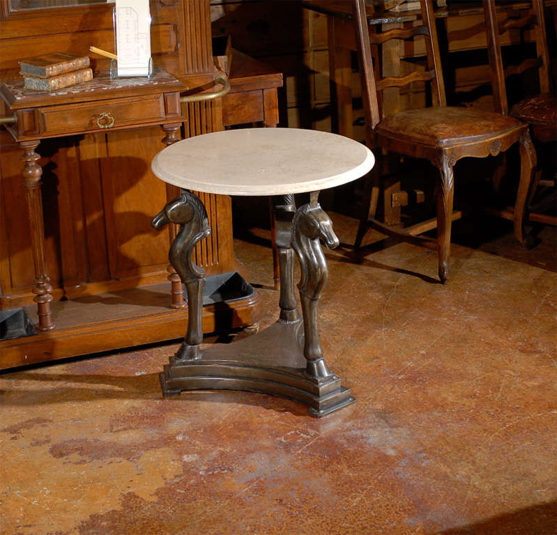 Bronze horse head table with marble top.