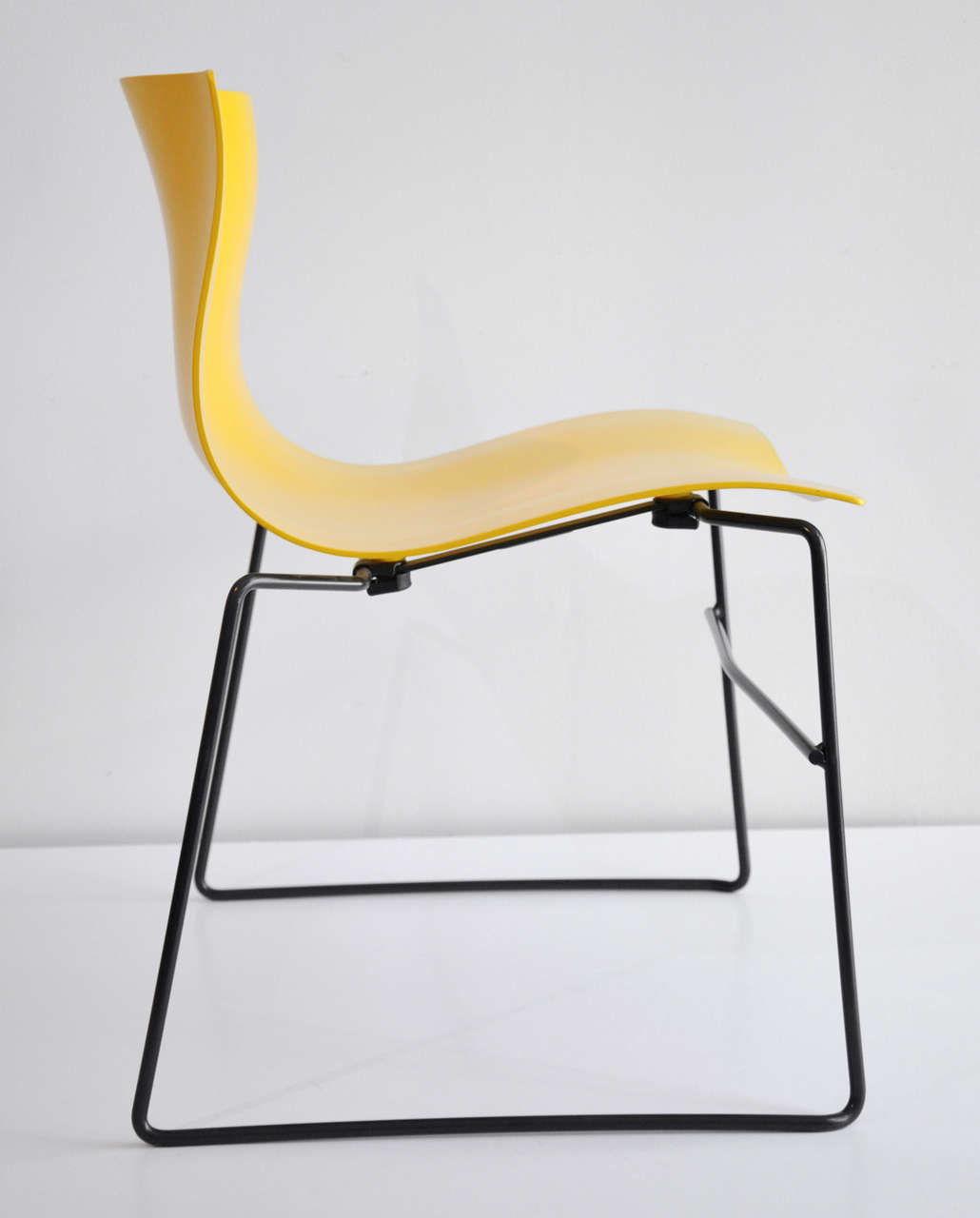 A pair of yellow handkerchief chairs designed by Massimo and Lella Vignelli for Knoll Studio.  This ergonomically sculpted side chair was designed to resemble a windblown handkerchief. A very comfortable stacking chair. Both have Knoll metal labels
