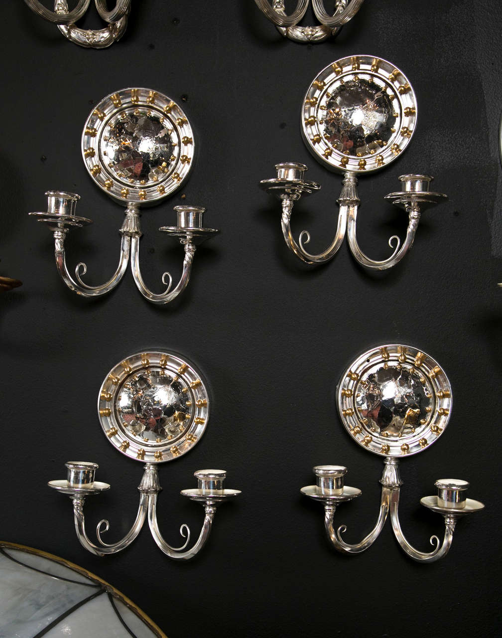 Set of eight circa 1920's silverplated Caldwell Sconces featuring  a crackled convex mirrored backplate.