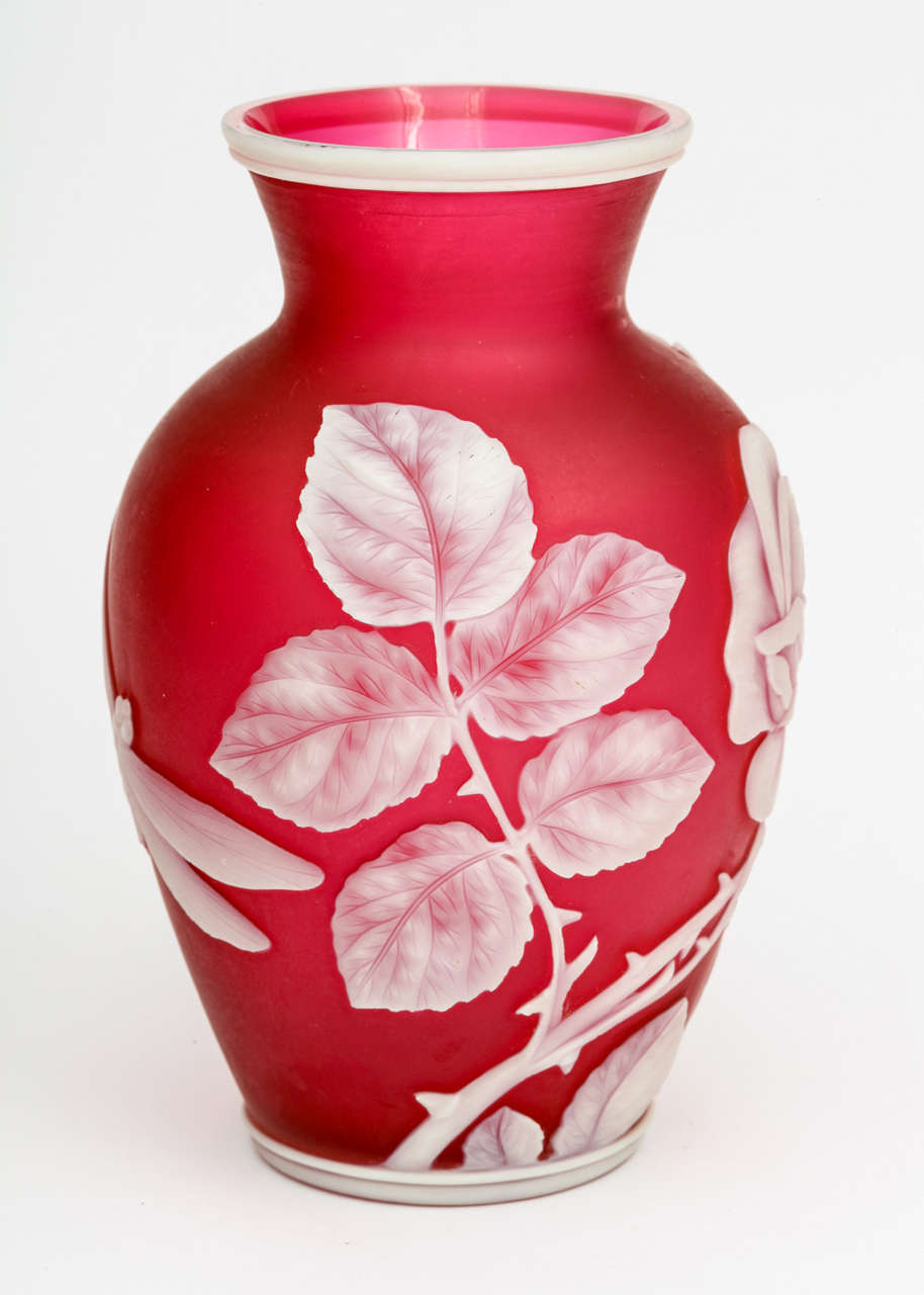 A fine Thomas Webb & Sons red and white cameo glass vase with a rose and bud on the front and dragonfly on the back