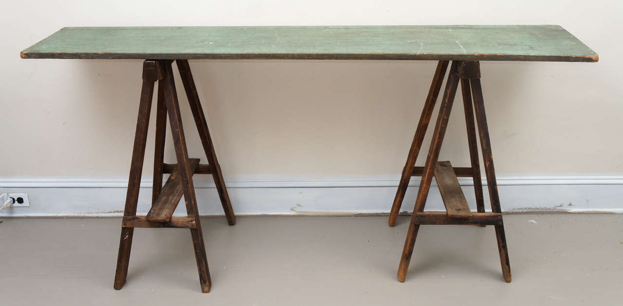A lovely surface and color. The height is 37 inches and the piece makes a practical and spare console or work surface.