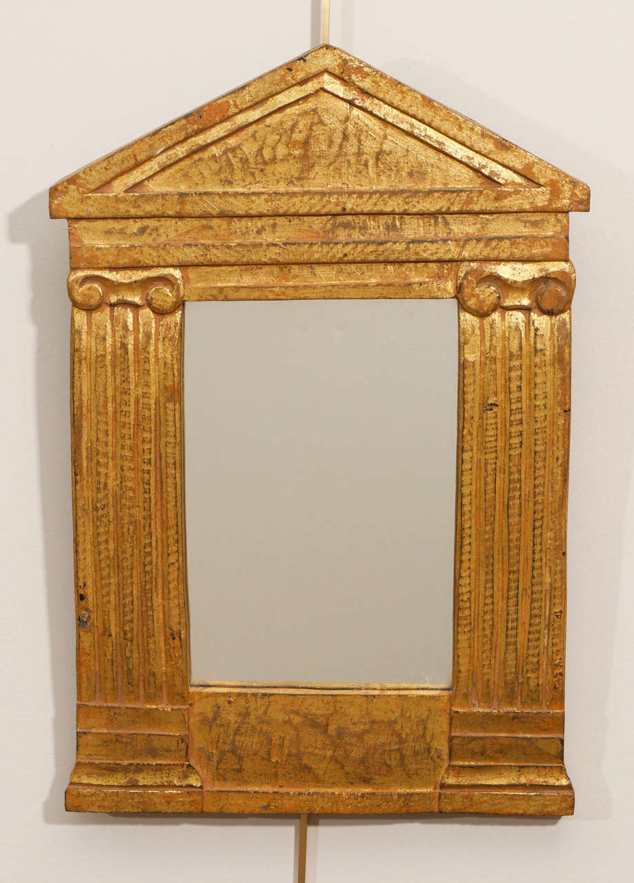 A charming gilt wood neoclassical style mirror--perfect as an accessory on a shelf or table.
