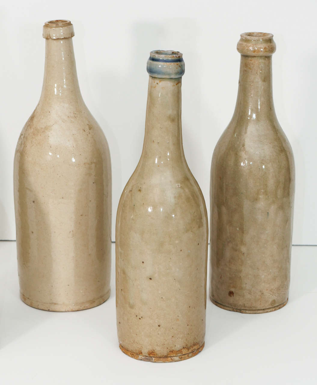 A collection of wine bottles from the Anjou region of France with a lovely, grey/green glaze.  These would be great as a centerpiece or as accessories in a kitchen. Priced separately.