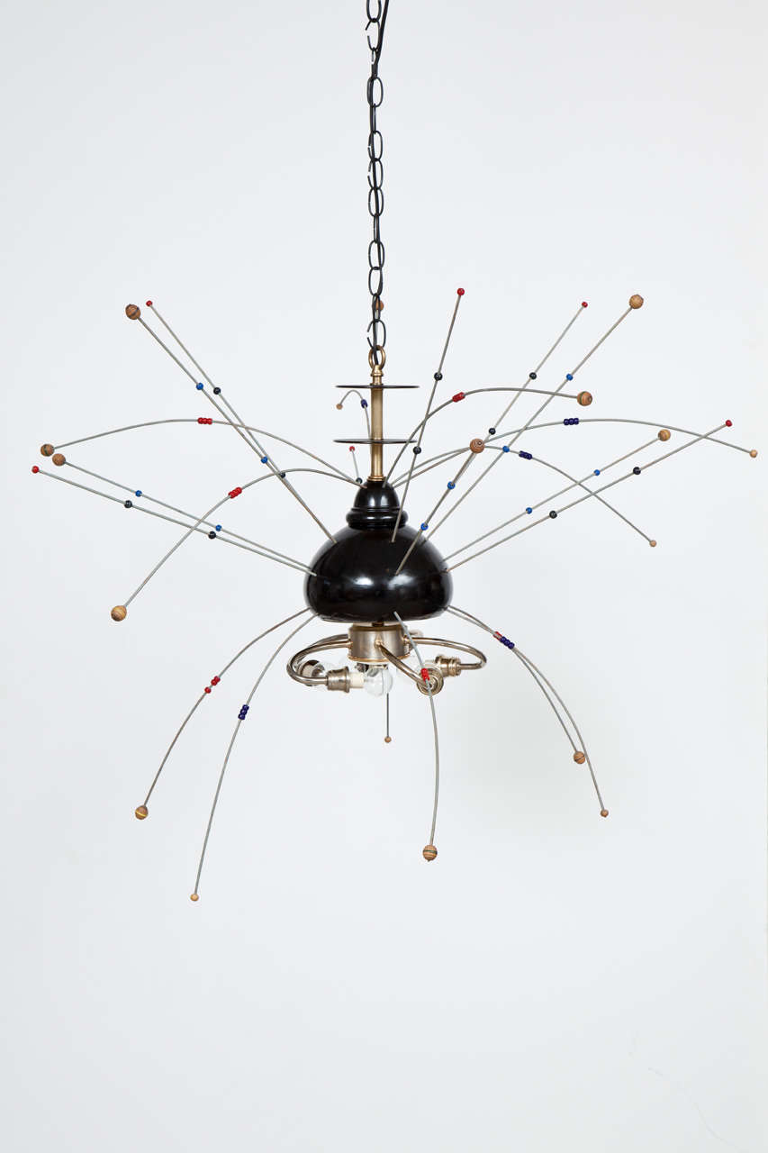 Chandelier with black lacquered wood body, brass accents and colorful 