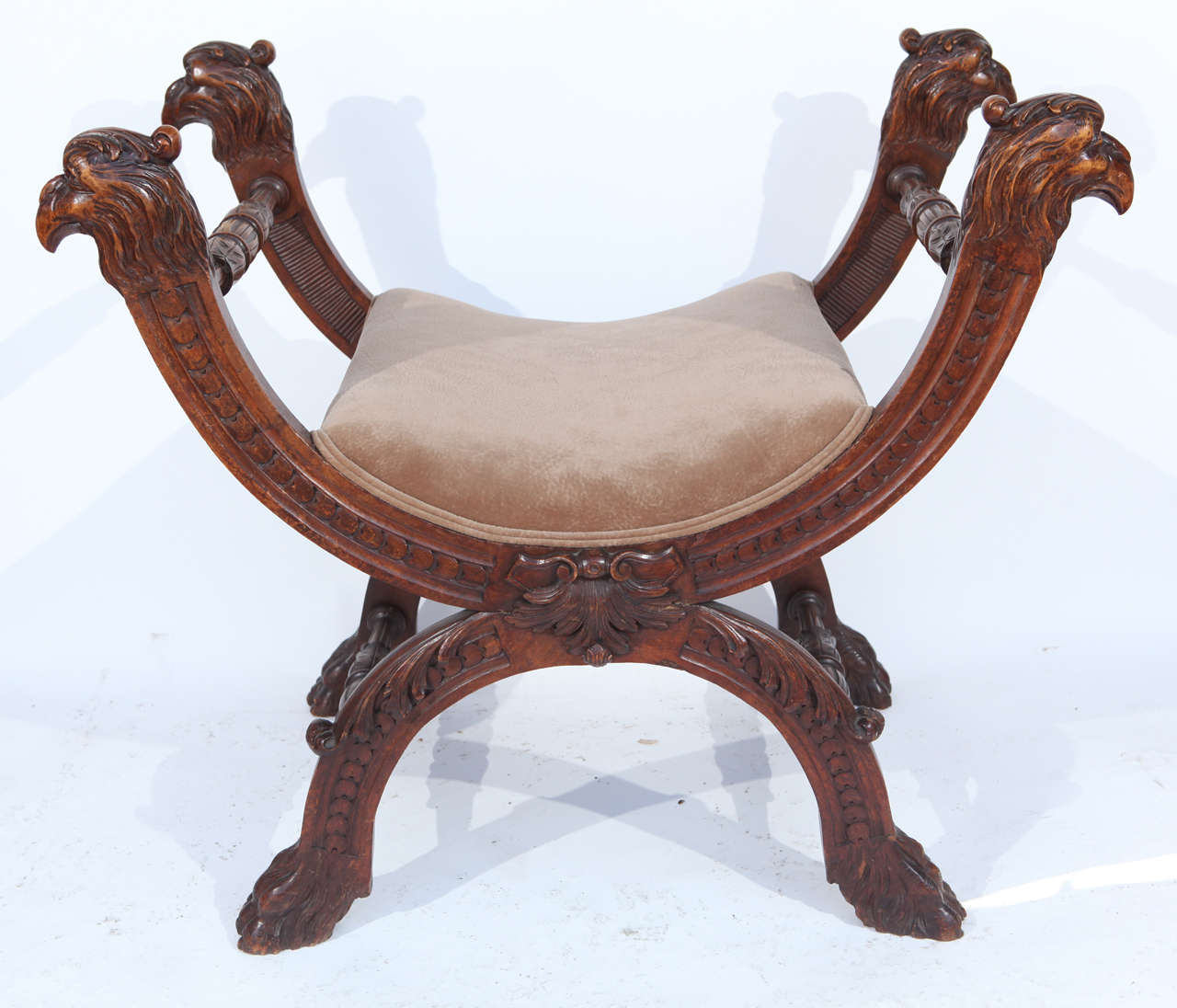 19th century Italian finely carved walnut stool with eagle heads and claw feet.