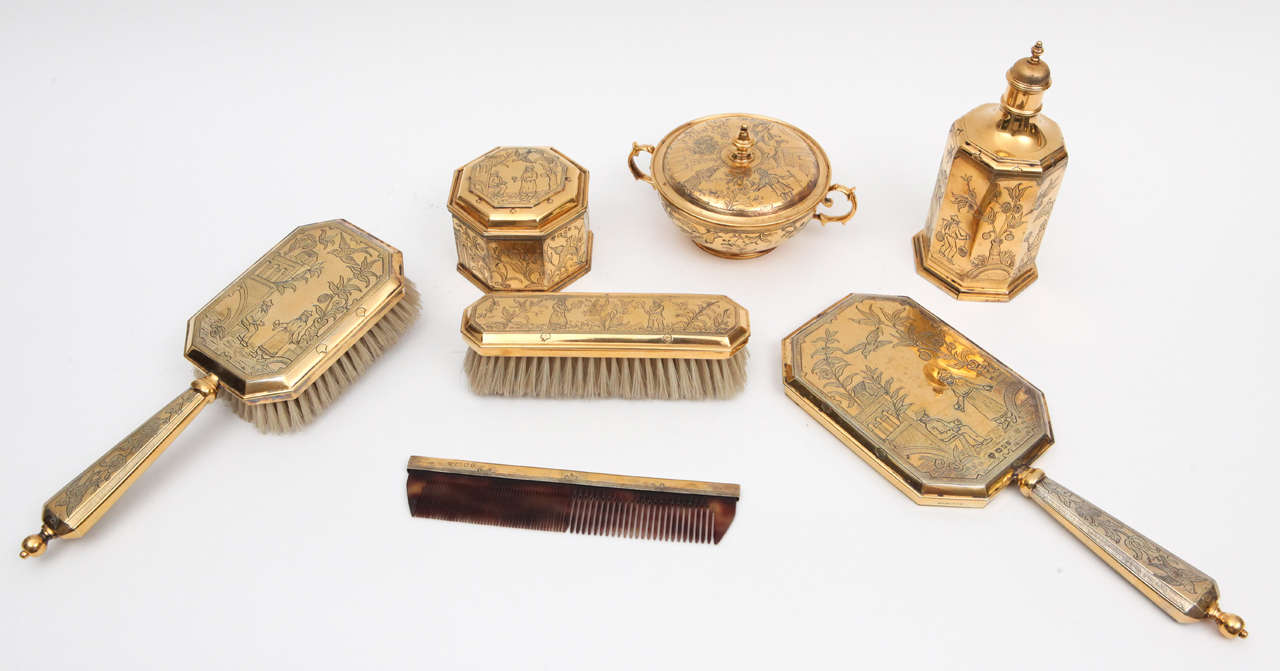Late 19th century English gold washed sterling vanity or dressing set with chinoiserie motif. Hallmarked England. The measurement below is for the hand mirror only.