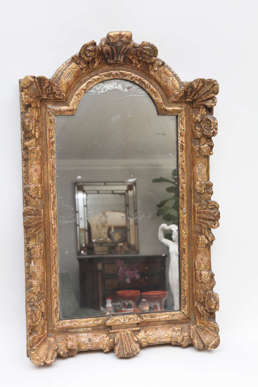 18th century French Regence carved giltwood mirror with original plate.