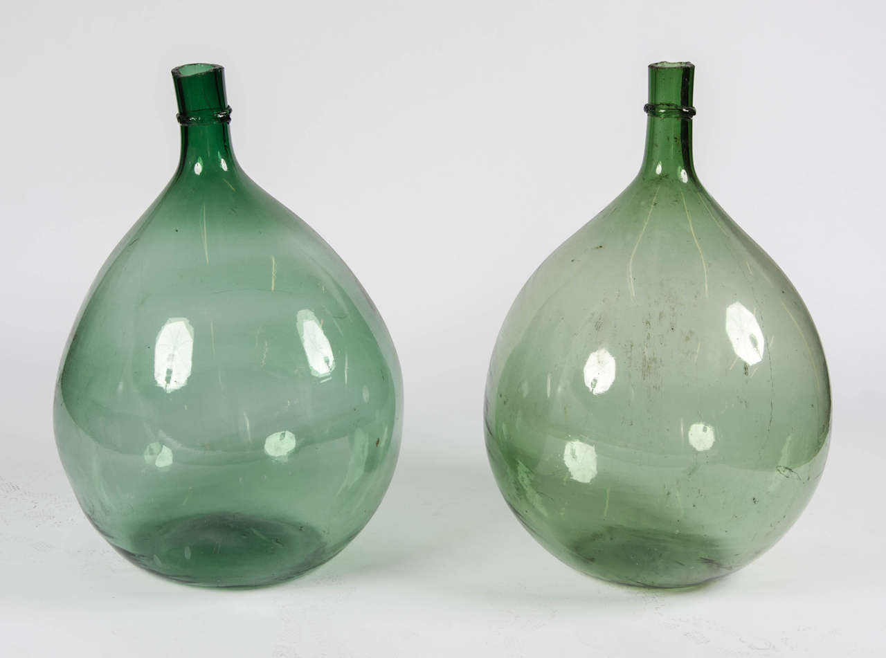 A stunning pair of late 18th century French handblown green in colure demijohns.

Maker unknown.