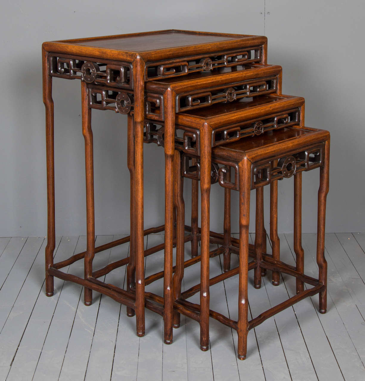 A very good quality set of four Padouk Chinese nesting tables, circa 1870. The tables were export and feature an apron around each one with a simple border design and solid top. The tables when together, measure 20 in – 51 cm in overall width, 14 ½