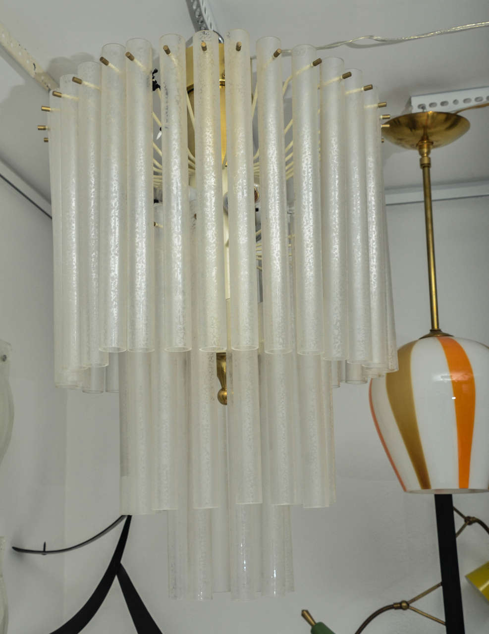 Three-tier chandelier composed of multiple frosted glass tubes, with brass details by Venini.