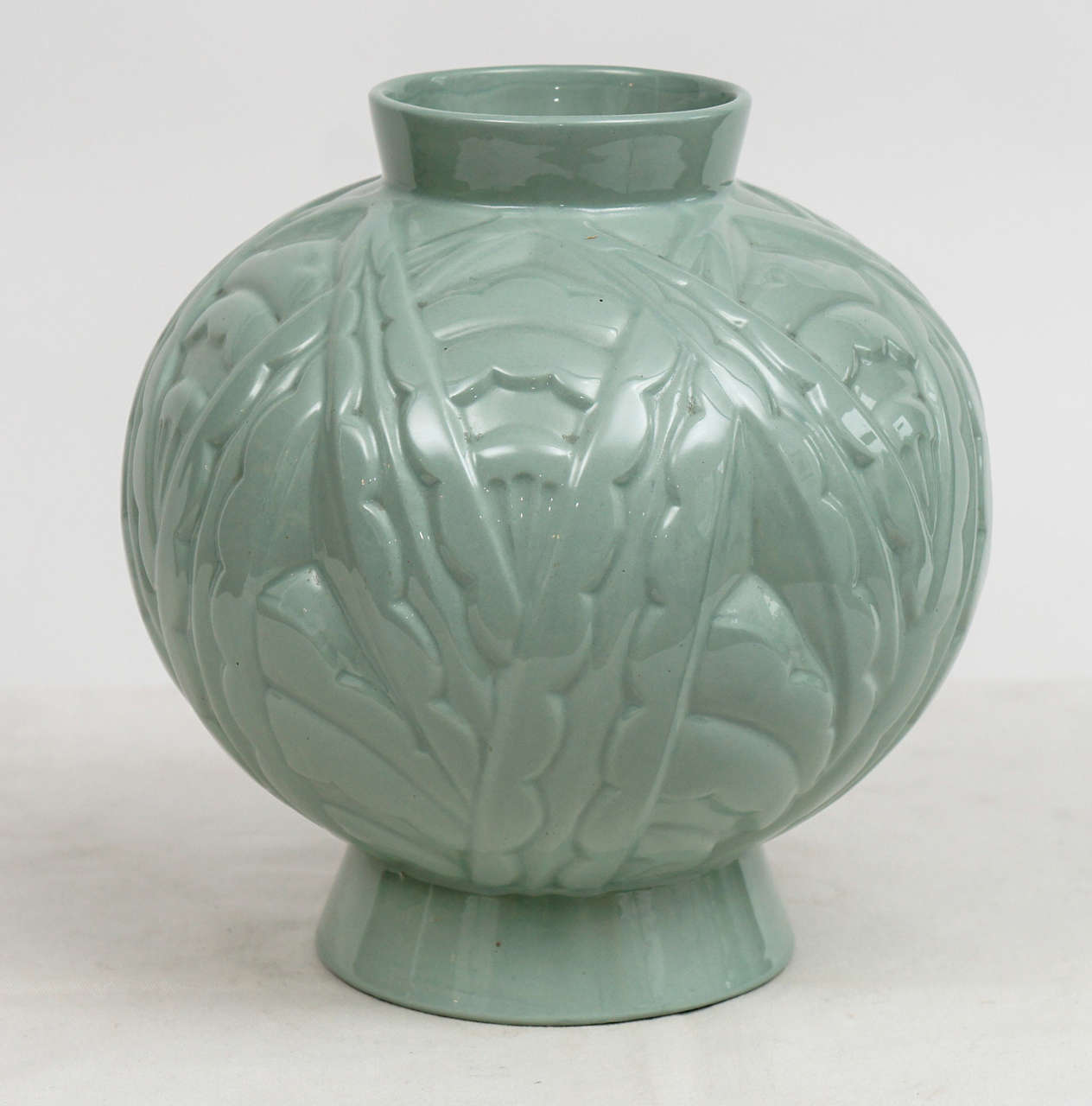 Classic deco vase on raised base. in subtle green,with period incised design. Well marked. Made in Belgium. Simple and stunning!