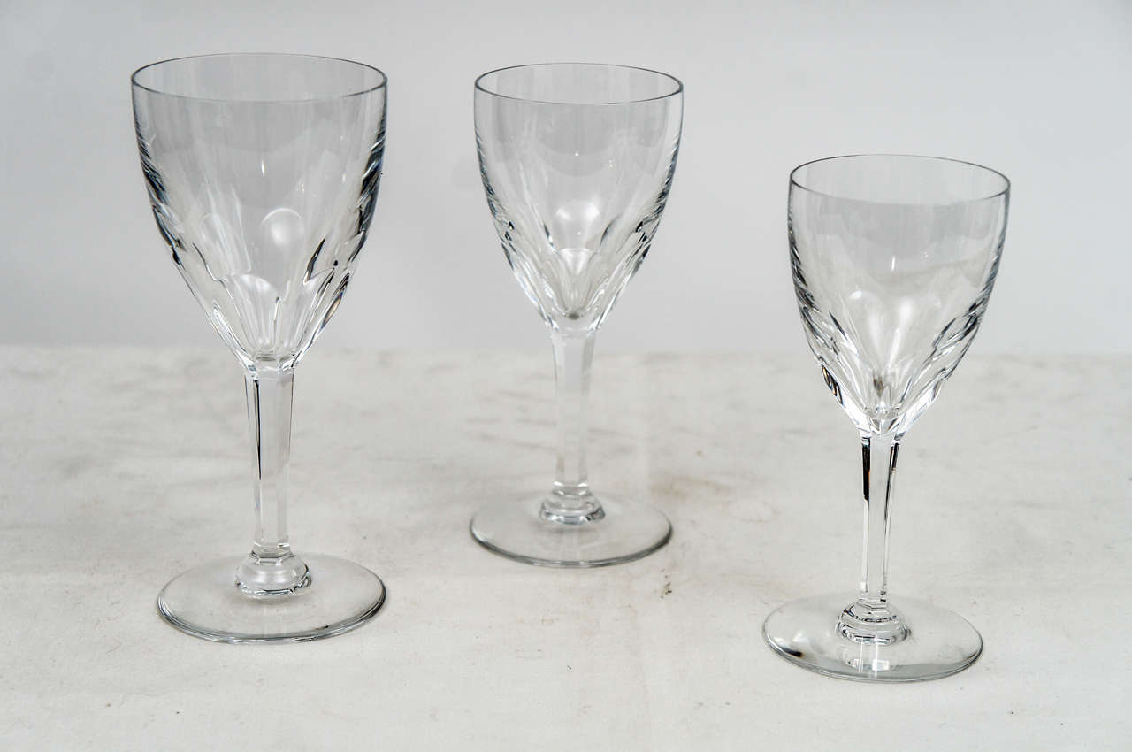 Thirty-six pieces, 12 each, of three kinds of Baccarat glasses in the Genova pattern. A six sided stem with cut thumb print floret pattern that was discontinued in 1981. Signed with Baccarat acid etched mark and in perfect condition. Suitable for
