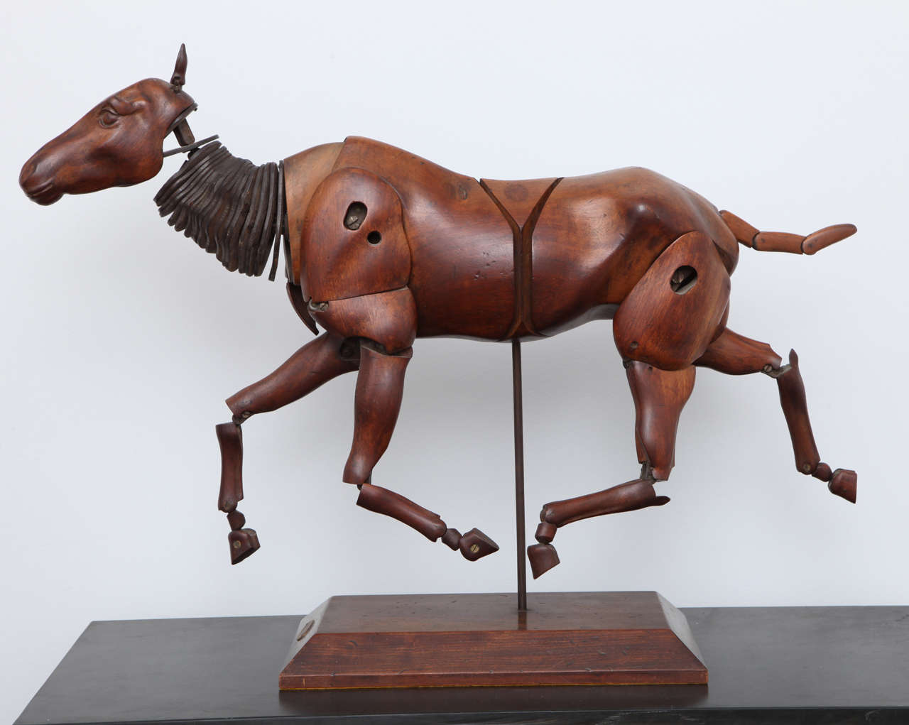 A 19th century French walnut and leather artist's model of a fully articulated horse on a wood base with a brass placque inscribed 