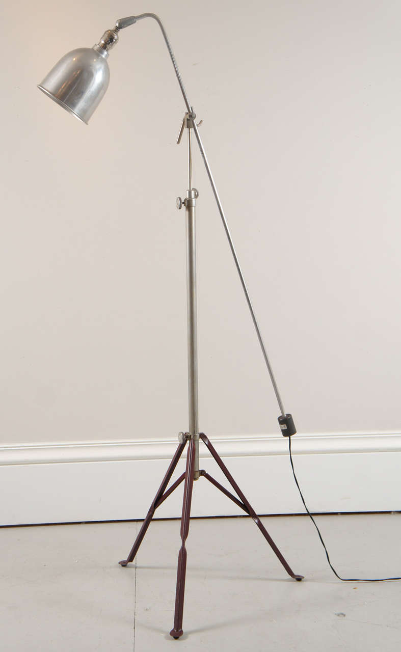 A steel and aluminum industrial floor lamp from the 1950's. Industrial with a polished look, this floor lamp is adjustable in a myriad of positions.