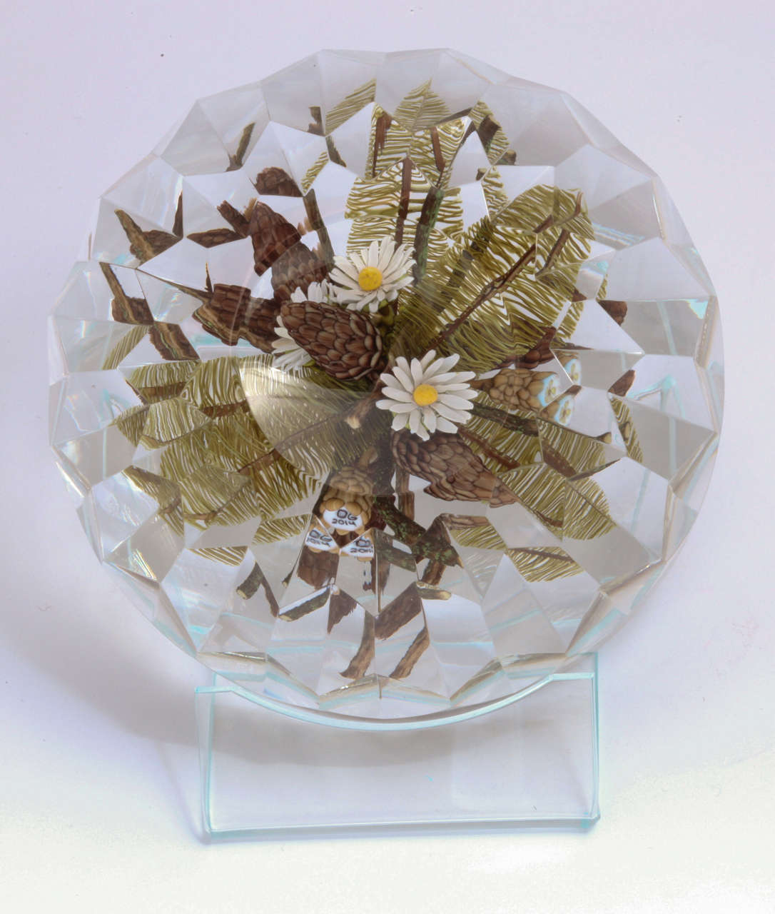 A beautiful David Graeber and Ed Poore paperweight plaque with pine cones and white daisies over fancy faceting