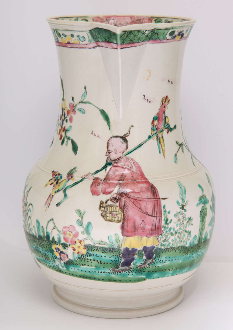 A rare and fine English salt glazed stoneware pitcher decorated with an Oriental man holding birds and birds in trees.