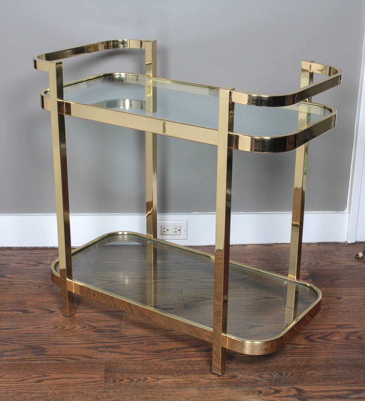A beautiful bar cart by Milo Baughman for DIA (Design Institute of America) with 2 glass shelves.