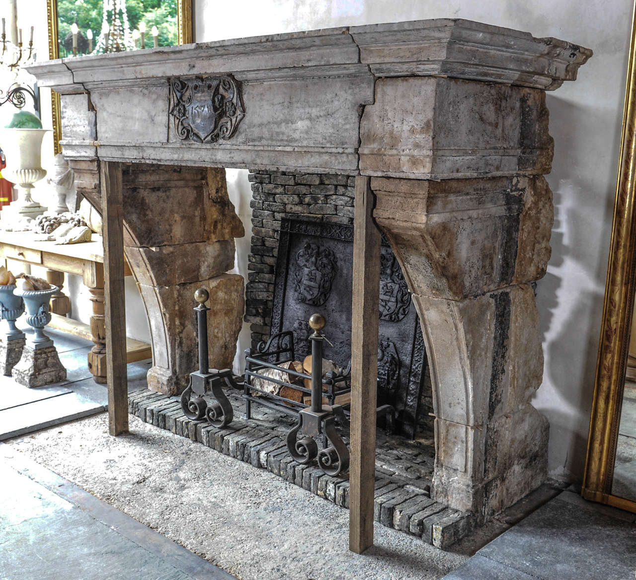 A spectacular French castle fireplace from hard French stone, with grey original patina. The front piece with a Medaillon bearing the date 1571.
