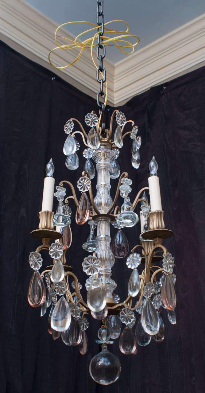 This continental fixture was probably made in Spain or France. The lead crystal prisms include both clear and pale mauve tear drops. Very good hand-cast brass frame. Chain, ceiling cap and hanging hardware included.