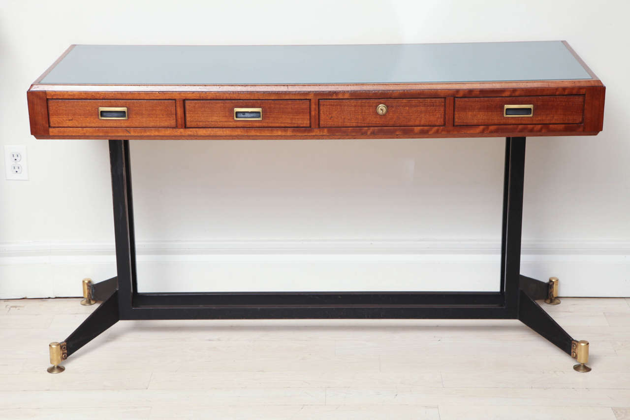 Stunning Mid Century Modern four drawer walnut console table with original brass hardware, ebonized metal and brass base, and reverse frosted glass top. From Naples, Italy.