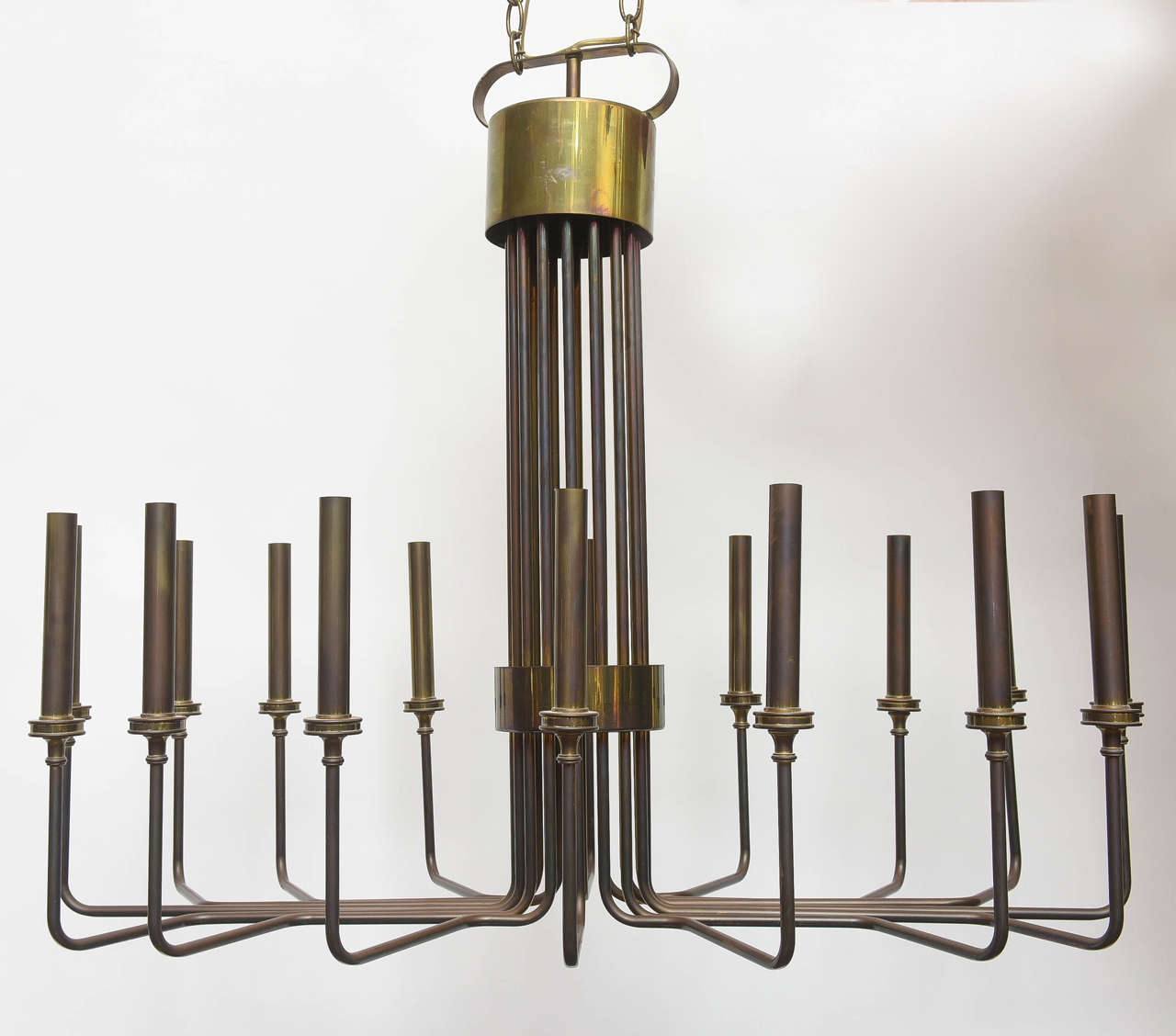 Sleek mid-century modern brass chandelier in oval shape, 16 lights.
