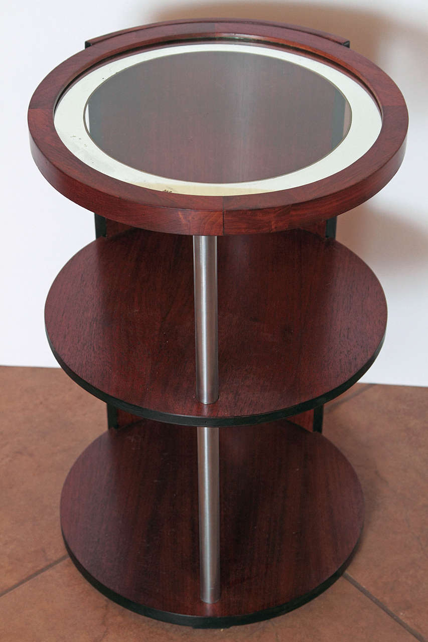 Walnut and brushed chrome, in the manner of similar Rohde designs for Kroehler and Herman Miller. Etched and mirrored glass top. No ball finial, like those other designs.

Excellent overall condition, with wear to original mirrored-band on top