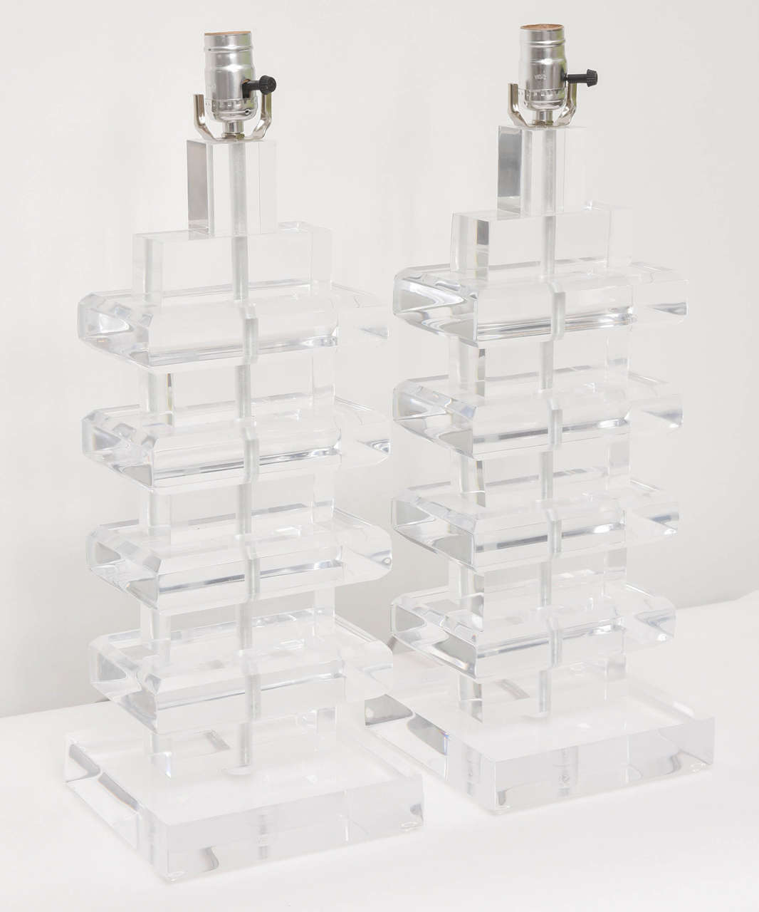 Pair of retro geometric stacked Lucite lamps with chrome hardware.