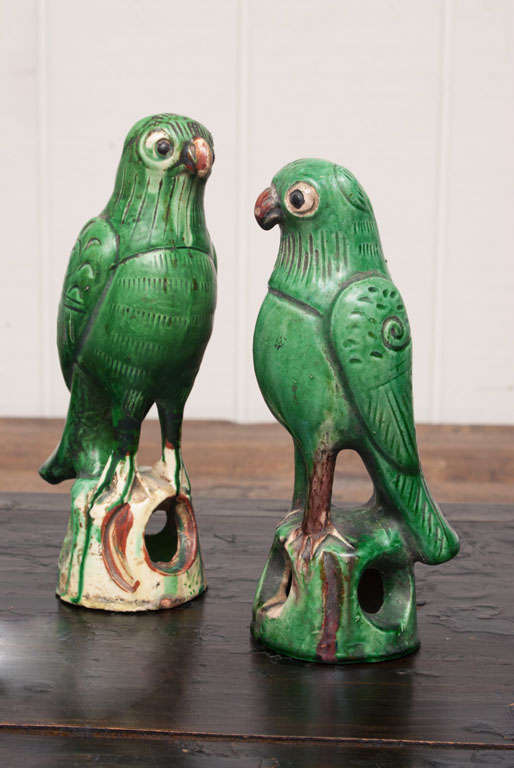 Pair of vibrant green glaze ceramic parrots from Shanxi, China.