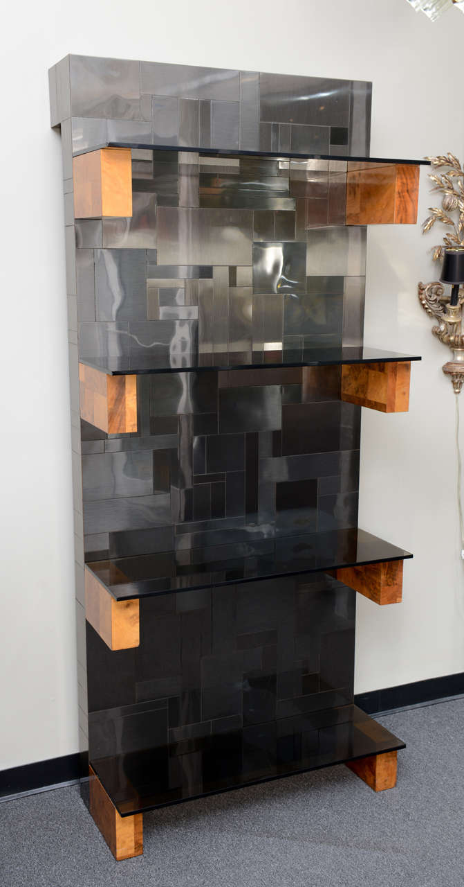 Beautiful "Cityscape" etagere shelves designed by Paul Evans for Directional. Rare, gunmetal finished steel over wood with burl wood block shelf supports for the four smoked glass shelves. Standing out from the wall 3 1/2", it is