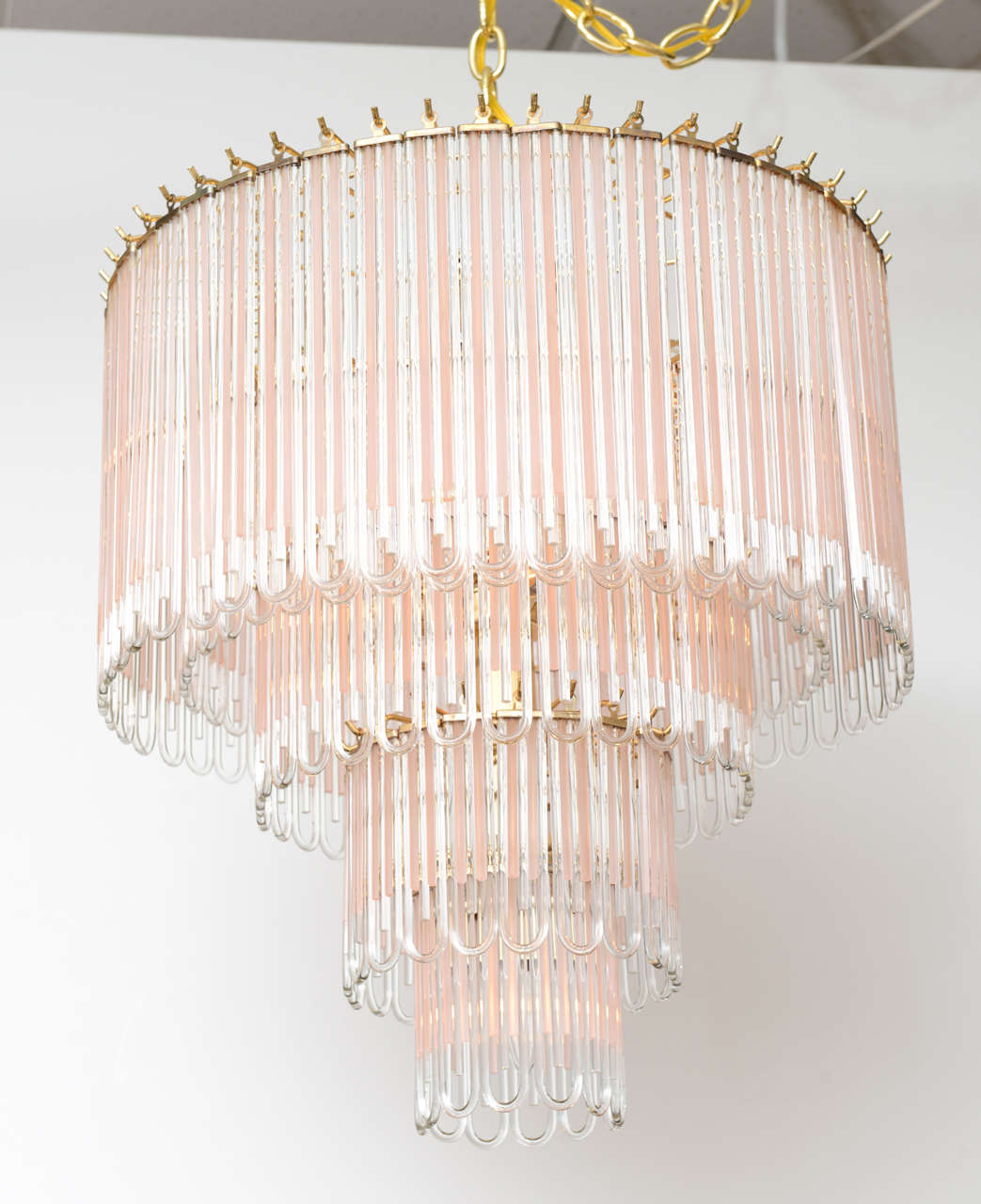 SOLD  Making quite an impression with its five tiers of looped tubes of glass in clear and frosted pink, centered in clear.  With 10 light sources making for exquisite lighting, romantic and graceful.  Heavy brass frame and mounts.

Fixture with