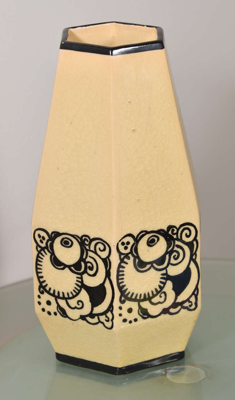 Designed by Jacques Adnet (French, 1901-1984)
Produced by Lusca, France, circa 1950
Marks:  LUSCA FRANCE ADNET, incised stylized A.
9-1/2 inches high (24.1 cm)

The vase with painted enamel stylized floral design.  Cracqueleur finish.  Wear to