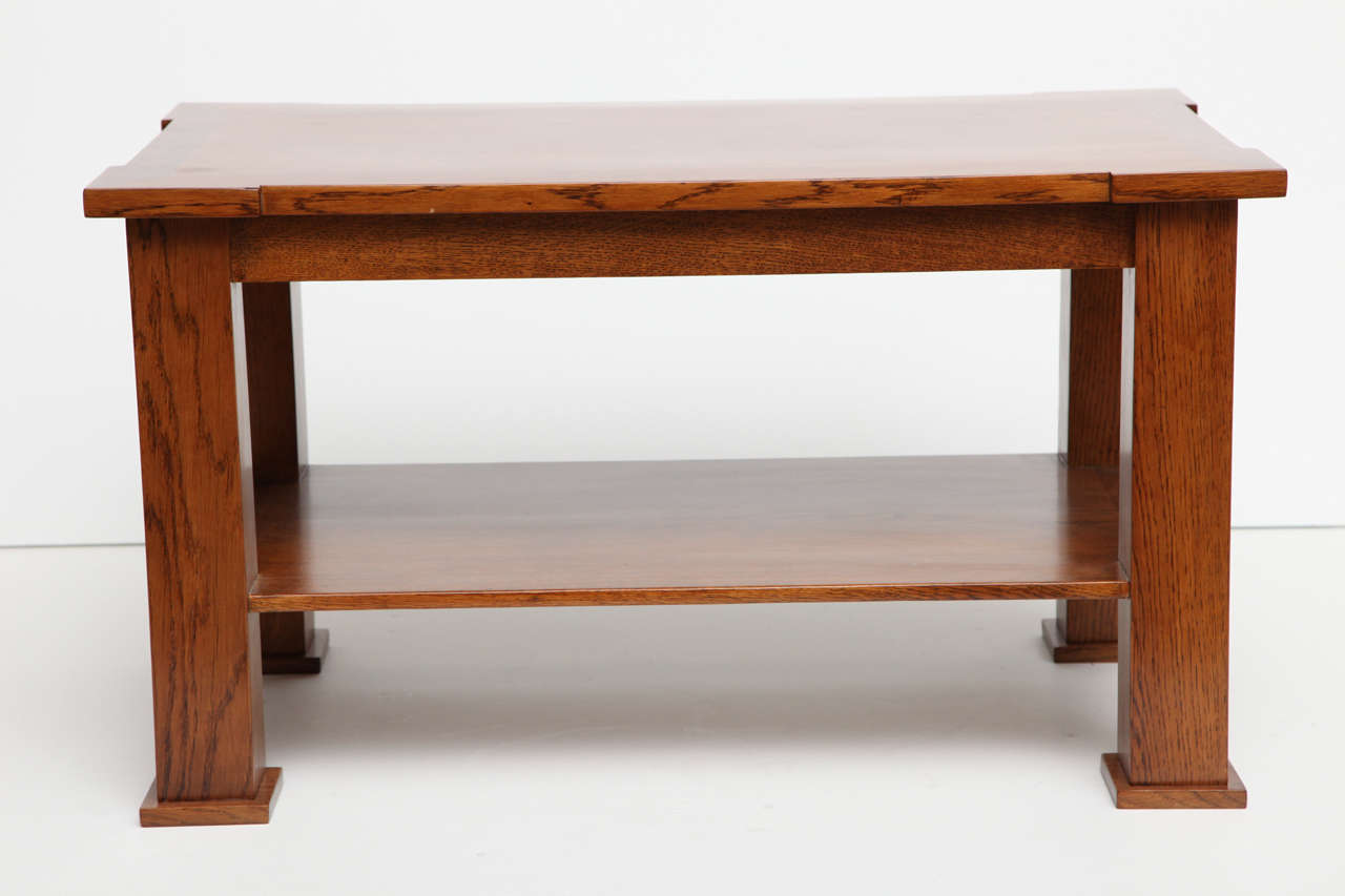 Despite its size, this petite coffee table of oak, made by Jacques Quinet, possesses the weight and the solidity of earlier neo-classical furniture--a source of inspiration for much of the famed designer's finest work. 