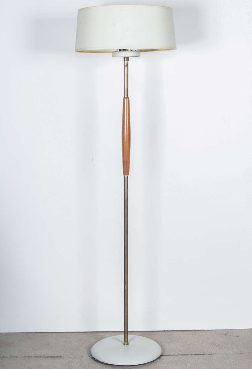 Floor lamp by Gerald Thurston for Lightolier, USA, circa 1950. Features a brass stem with wood accent and off-white metal base. Includes new custom drum shade and diffuser.