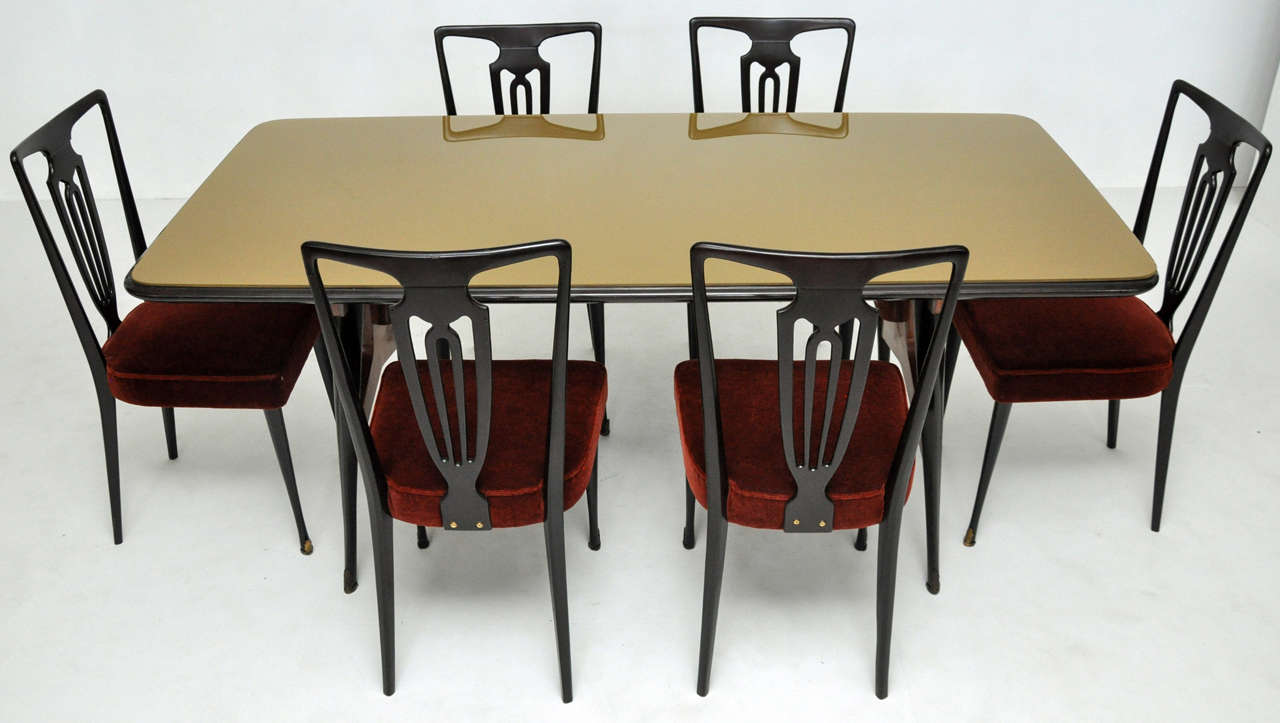 1950's Italian modern dining set.  Dining table in Italian ribbon mahogany with ebonized legs.  Original gold glass top.  6 dining chairs have been reupholstered in Mohair.

**Matching sideboard and bar cabinet available separately.

Table