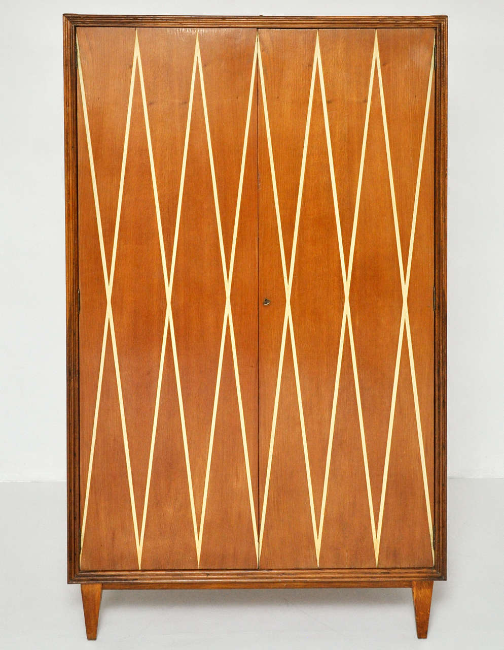 1950's wardrobe cabinet.  Made in Italy.  Great diamond pattern design on doors.

**A second cabinet made to accompany this cabinet is also available, as well as matching pair of nightstands.