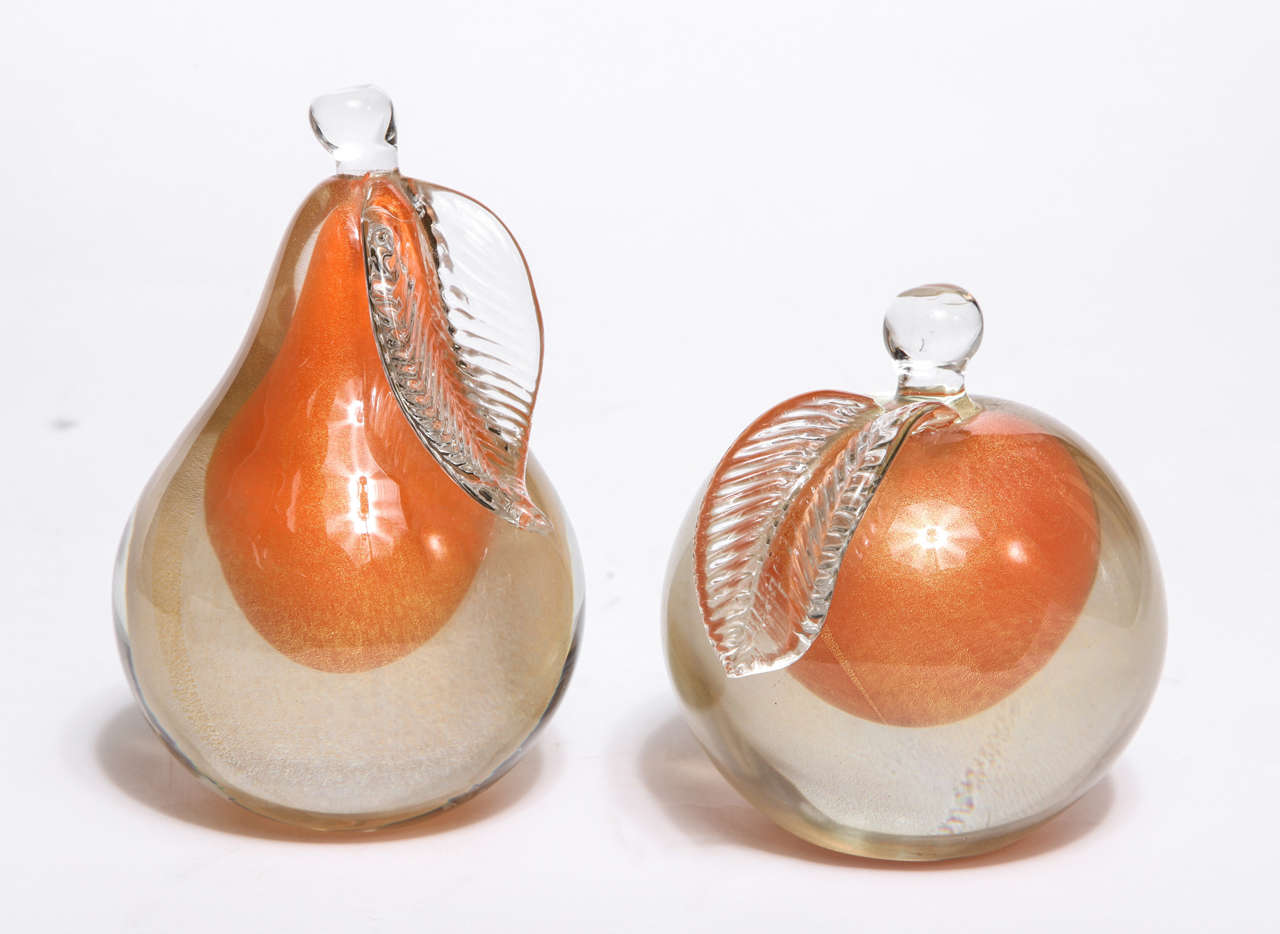 A pair of Barbini sommerso Murano fruit bookends. Orange glass and gold flecks encased in clear glass.