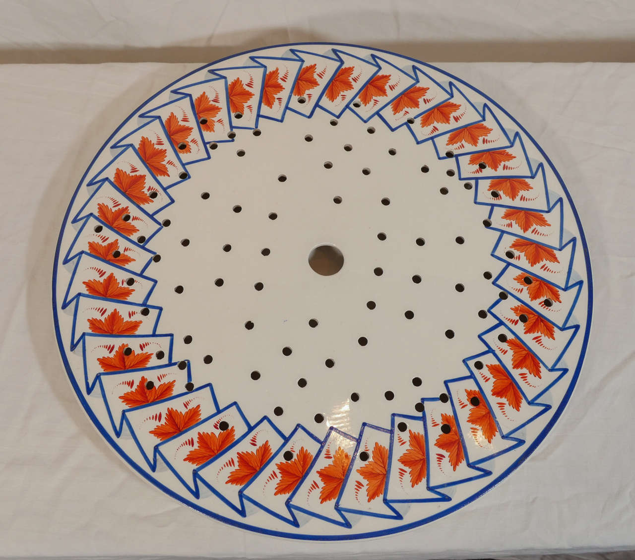 A pair of large pearlware drainers decorated to the border with cobalt blue accordion folds enclosing orange leaves. This rare pattern has a modern look.
In this pattern we also have in the shop:
A large oval platter, 21.75