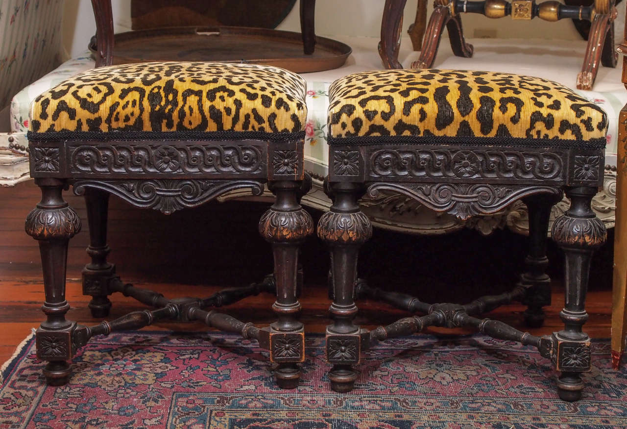 Pair of 19th c. Italian Dark Walnut Stools with x stretcher and carved frieze. Now upholstered with Clarence House Leopard Silk Velvet.