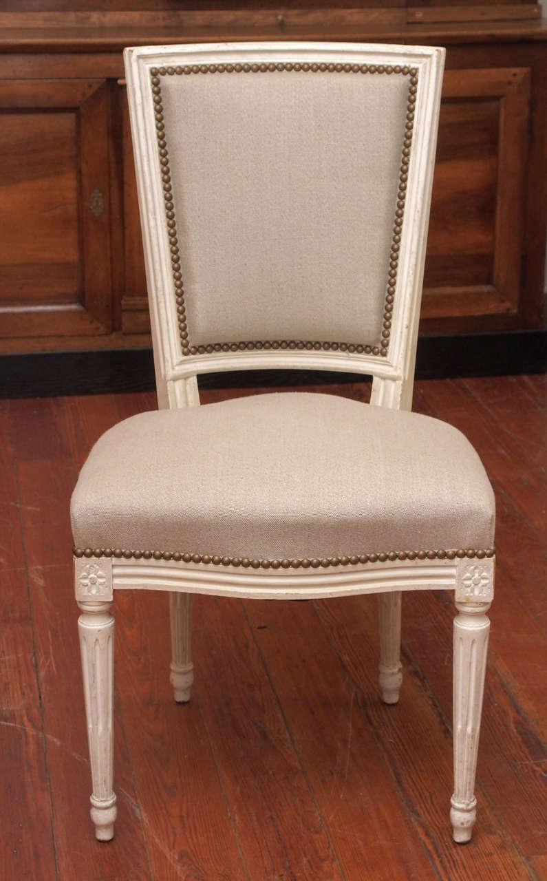 Set of 8 19th century dining chairs.  Newly upholstered in natural linen.