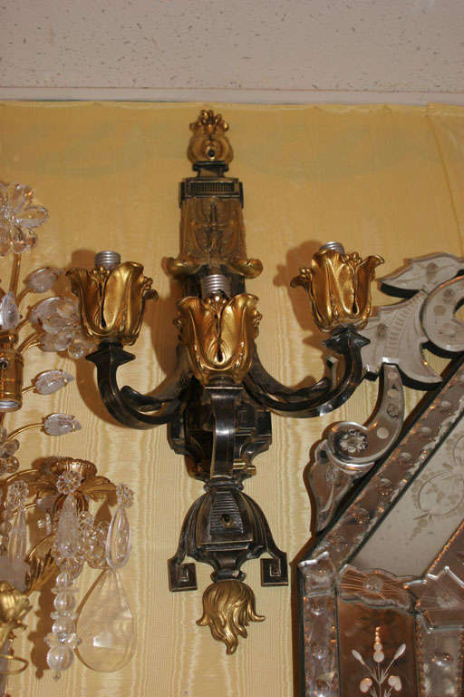 Fabulous two-toned patinated and gilt bronze three-arm wall sconces in the Caldwell style.
Stock number: L80.