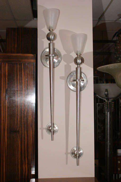 Pair of highly decorative French wall-sconces designed for Maison Jansen in the 1940s, in brushed steel with frosted glass shades. Shades may be different from the ones pictured.