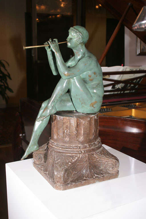 Maurice Guiraud Riviere (French, 1881-1947)

'Flute Player', a green patinated bronze sculpture depicting a nude female figure playing her flute and sitting on a stone base beautifully carved in the shape of a classical column fragment. Incised