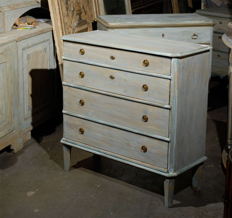 A 19th Century Swedish Gustavian Style Four-Drawer Painted Wood Chest. Tapered and Angled Feet.