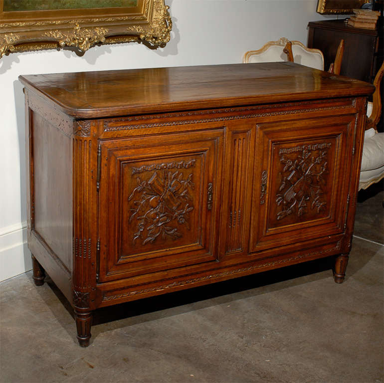 Early 19 th.c. French Buffet with carved music motif on doors and nice patina.