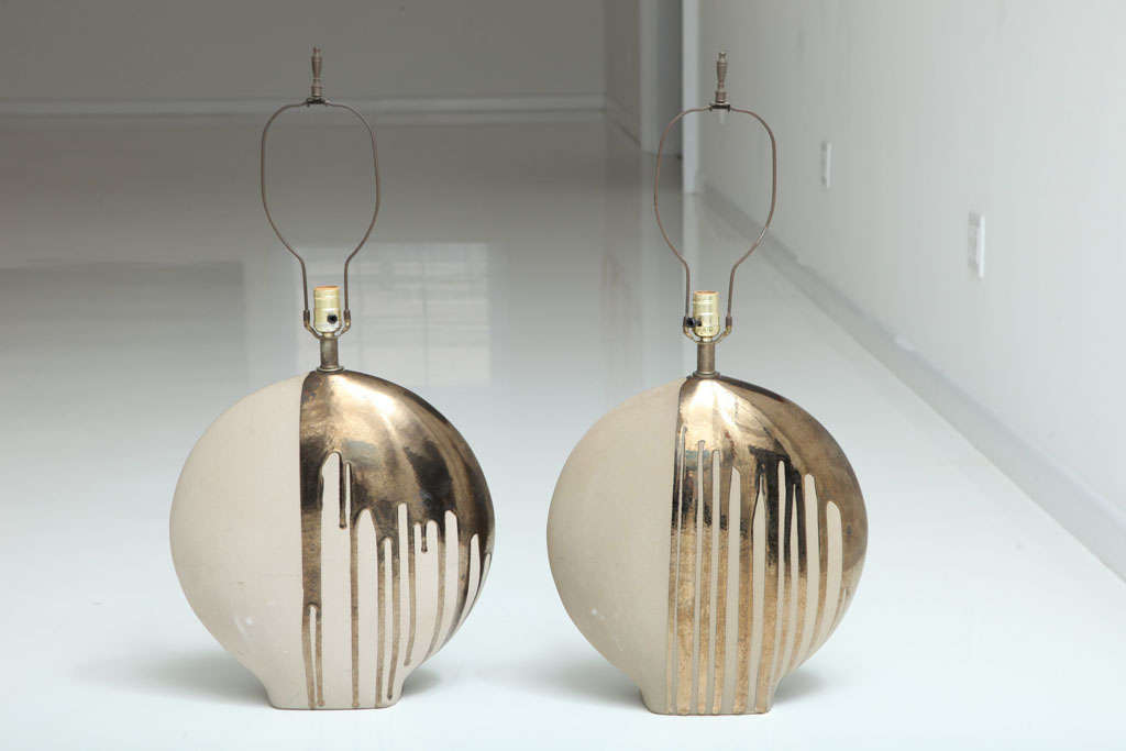These oversized pill shaped table lamps with metallic dripping glaze are extremely unique and artistic.