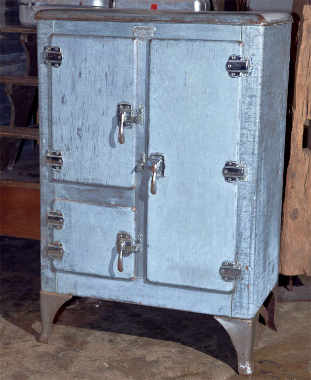 Industrial metal clad ice box, c. 1920-30, on curved steel feet, with the maker's label, 