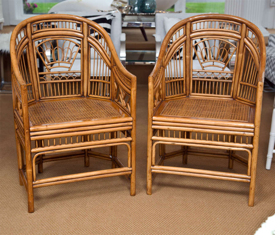 Bamboo chairs with nice fretwork detail, caned seat and white linen cushion.