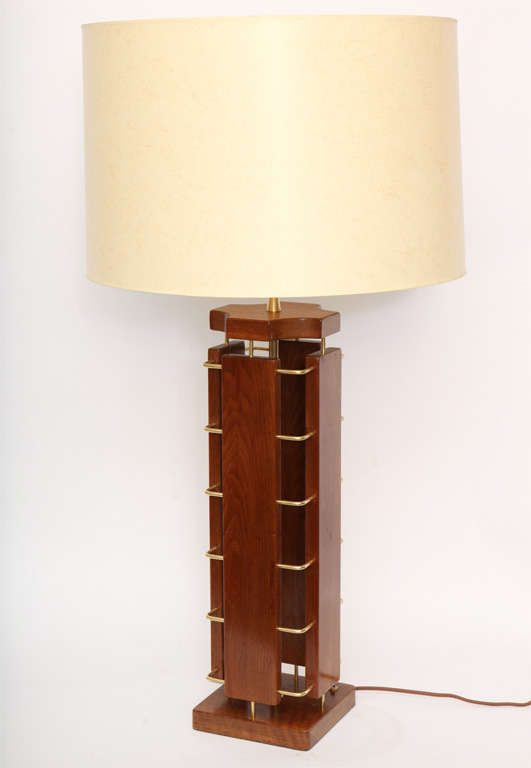 A 1950s architectural wood and brass table lamp.
New sockets and rewired
Shade not included